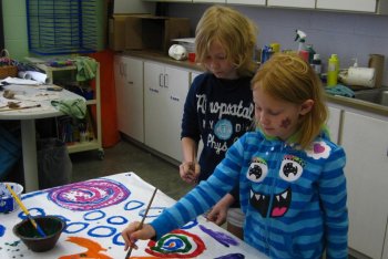 Two students painting in the art room.